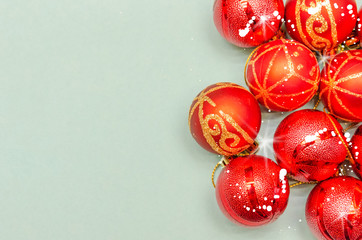 Christmas background with copy space. Top view of Christmas red balls on light blue background. Copy space.