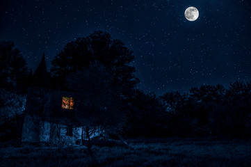 Naklejka premium Vintage dworek w nocy z chmurami i gwiazdami. Zimna jesienna noc