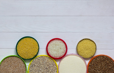 Rice, millet, pearl barley and other cereals on a white background, top view,copy space