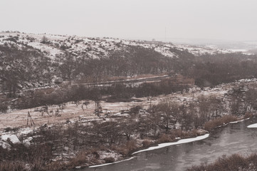 Fototapeta na wymiar Panoramic view from shore near river on winter day.