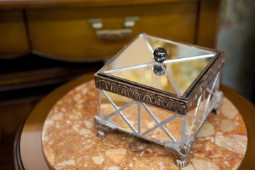 Jewelry box of mirrors on a wooden table