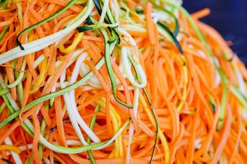 Long strands of spiral cut carrots and zucchini