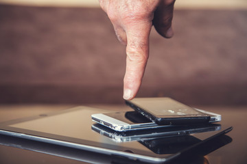 man hand phones with tablet