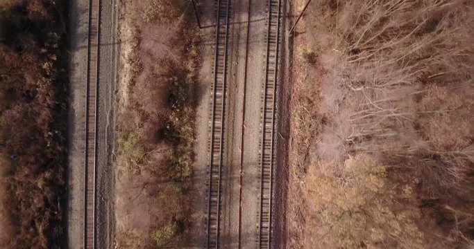 Drone flying straight down over train tracks fall