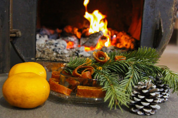 in the oven the fire burns, a mug of tea, spruce, Christmas atmosphere, Christmas composition, burning hearth in the house, selective focus