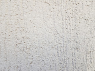 Concrete wall texture with a relief of gray paint.