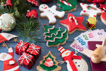 Christmas cookies and gifts with preparation with passport and money for holiday