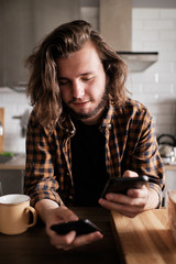 Man synchronizing two smart phones