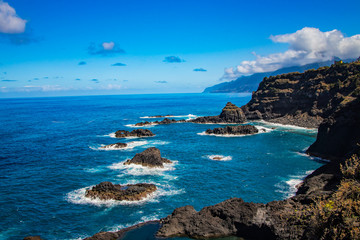 Swimming natural pools of volcanic lava in Seixal, Madeira island, Portugal, Europe. There is beautiful view on sea cliffs and waves of Atlantic ocean.