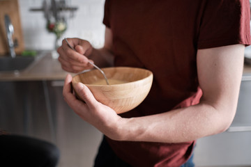 Close up of a man stirring egg yolks