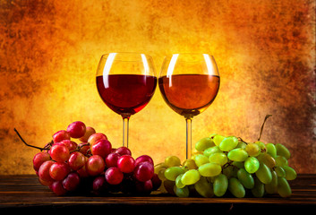 Wineglasses and grape on table