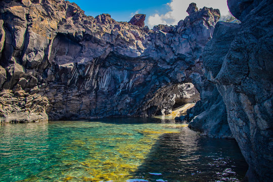 Swimming natural pools of volcanic lava in Seixal, Madeira island, Portugal, Europe. There is beautiful view on sea cliffs and waves of Atlantic ocean.