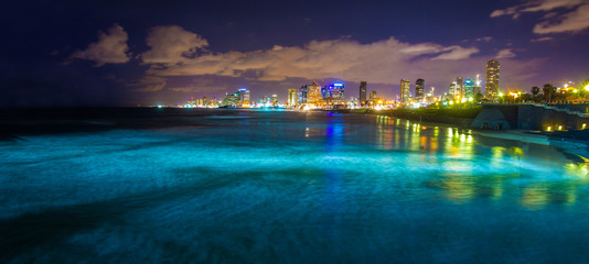 Fototapeta na wymiar Night city - Tel Aviv and blue Mediterranean sea