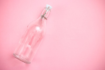 Reusable bottle on pink background. Glass bottle. Copy space. Retro