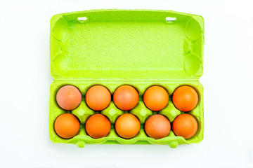Eggs in green paper packing box on white backgroun. Sustainable lifestyle