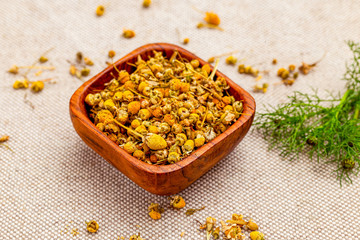 Dry chamomile herbs on linen background.  Healthy lifestyle. Natural ingredients