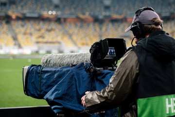 Professional camcorder in the stadium. Broadcasting a football match. Live