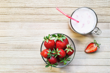 Yogurt with fruit filling from strawberries and banana on the surface boards