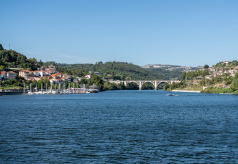 Fototapeta premium Small marina with power boats and docked river cruise boat in the Douro valley near Porto