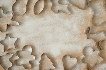 cookie cutters and cookies not a wooden background with icing sugar