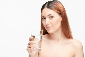 Portrait of a beautiful young woman with glass of water