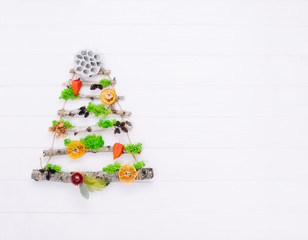 Christmas tree from natural dried plants on white wooden background