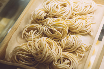 Pasta fresh (italian spaghetti) in classic style on white background. Homemade cooking