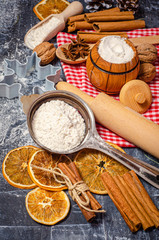 Ingredients for cooking Christmas baking. Flour and spices on kitchen table top view. Bakery background.