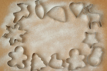 cookie cutters and cookies not a wooden background with icing sugar