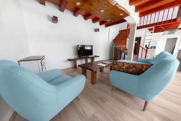 Living room with blue armchair and sofa