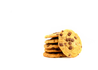 Some sweet cookies with chocolate laying on top of each other and one is near on isolated white background.