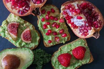 avocado or guacamole toast with red fruits
