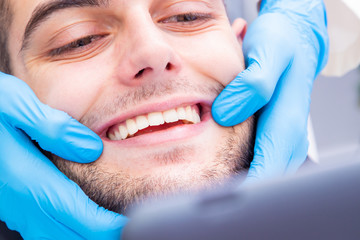 dentist showing the patient's smile or teeth