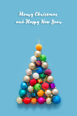 Christmas balls lie in the form of a Christmas tree on a blue background