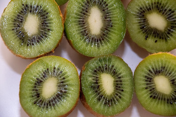 group of slices of kiwi on white background