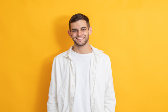 portrait of smiling young man in color background