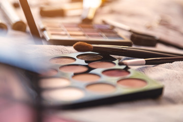 Obraz na płótnie Canvas Palette of multi-colored cosmetics eyeshadows and brushes