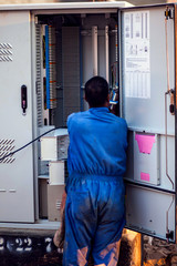Electrician worker checking transformation box on the street