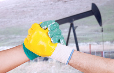 men handshake at petrol oil working place