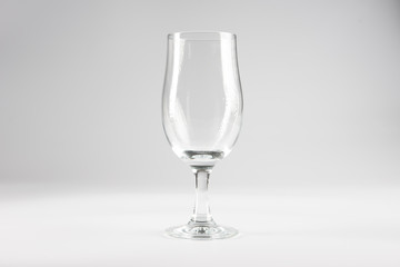 An empty beer glass set against a white background