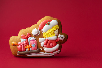 gingerbread cookie of Santa postman on red background. Traditional Christmas food. Christmas and New Year holiday concept.