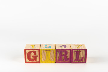 A child's alphabet toy spelling word block set, spelling out the word girl