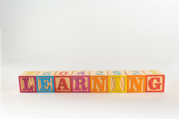 A child's alphabet toy spelling word block set, spelling out the word learning