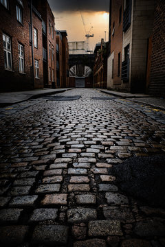 Narrow Cobbled Street In The City Of Manchester UK At Sun Set