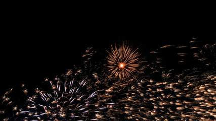 A beautiful Fireworks light up the sky with dazzling display on dark background.