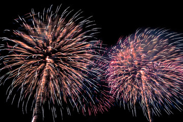 A beautiful Fireworks light up the sky with dazzling display on dark background.