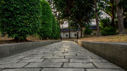 Paving stone road. Old pavement of square cobblestone sidewalk.