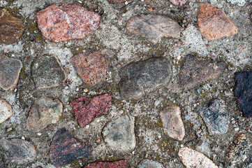 Background in the form of a fragment of a stone wall with textured stones from a colored rubble.