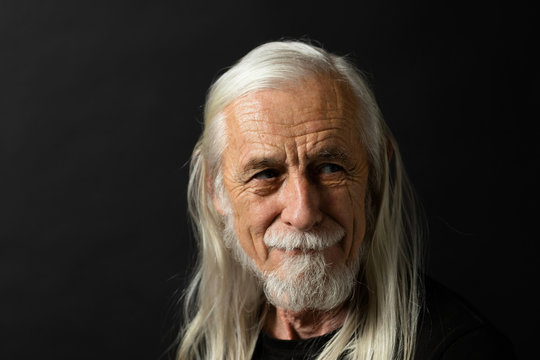 Portrait of beautiful old man with loose long gray hair. The man is smiling  and looking at right side of photo. Stock Photo | Adobe Stock