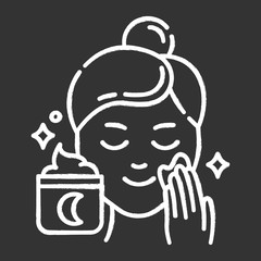 Applying night cream chalk icon. Skin care procedure. Facial treatment product. Sleeping cream for evening beauty routine. Dermatology, cosmetics, makeup. Isolated vector chalkboard illustration